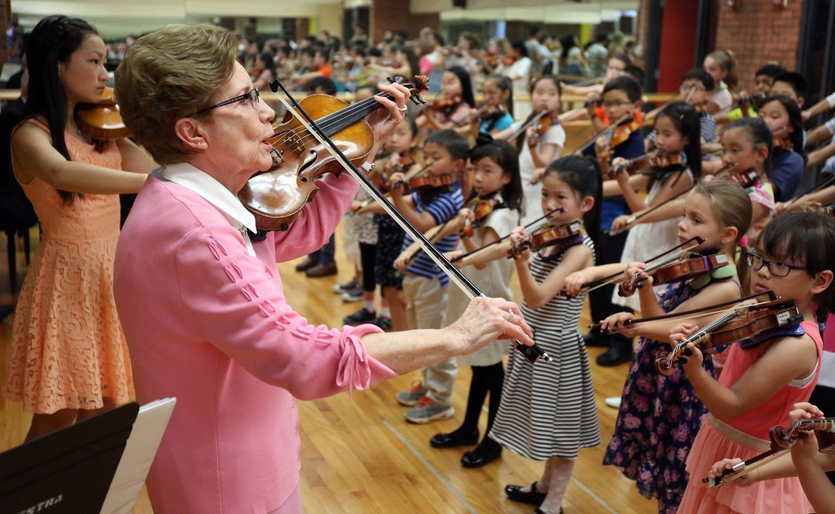 Magical Strings of Youth teacher Betty Haag teaching students